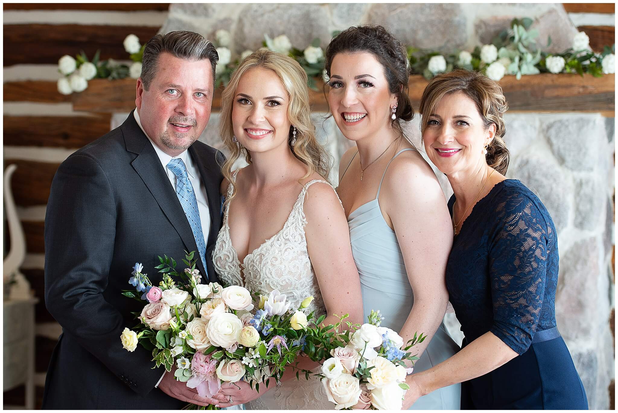 family photo of a bride, her parents and sister