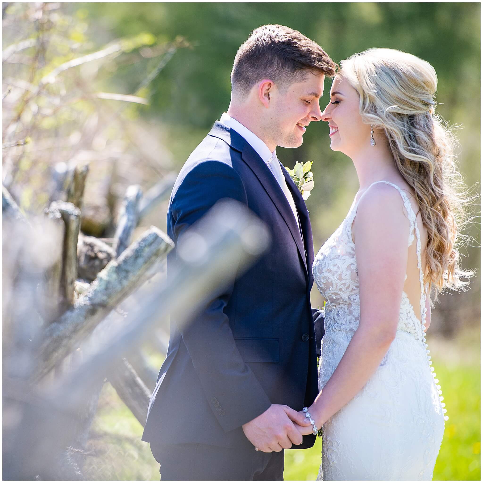a bride and groom nuzzle noses and smile during their wedding photography at Stonefields Estate