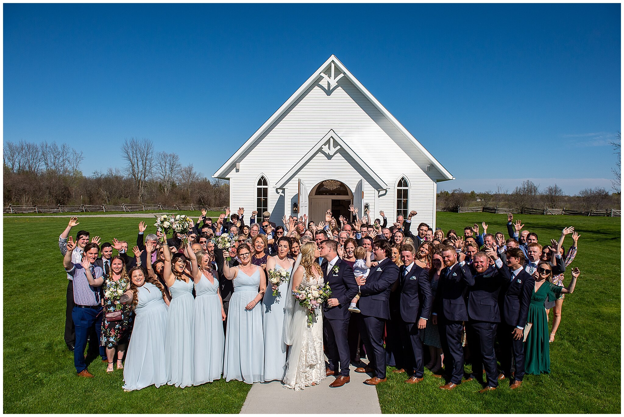 large group photo of a bride and groom and all their guests taken outside the Ceremony House at Stonefields Estate in Ottawa