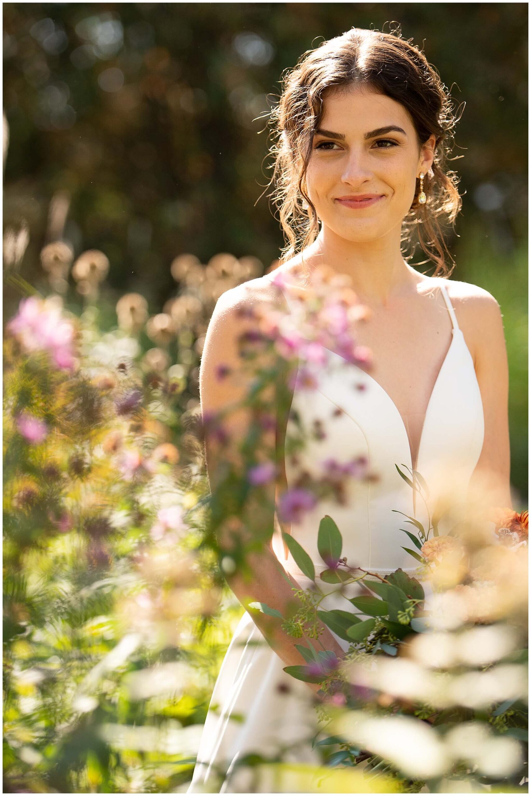 a bride smiling at her groom in the midst of wildflowers in the Heritage Gardens of Strathmere wedding venue in Ottawa