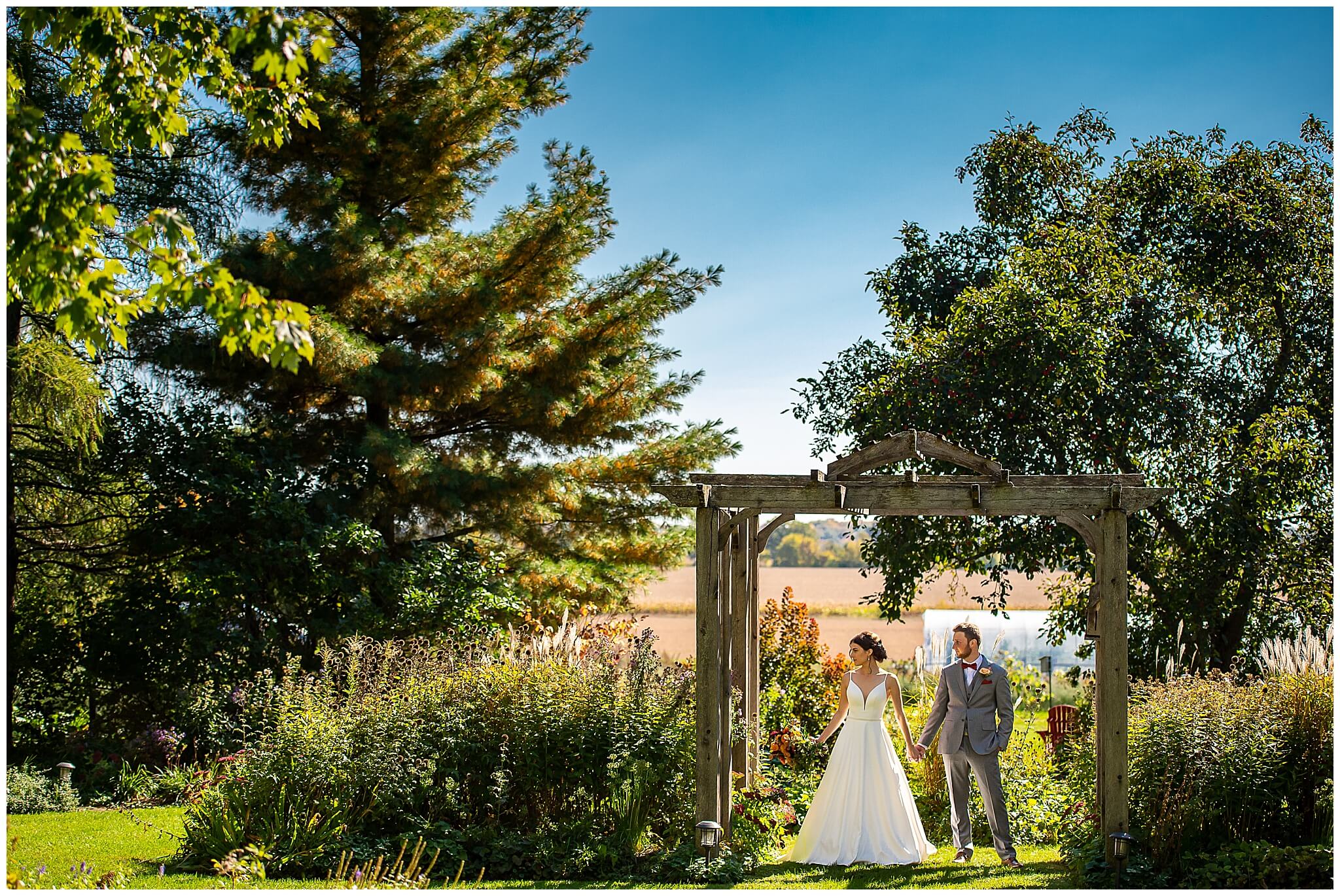 a bride and groom holding hands in the gardens of Strathmere Weddings 