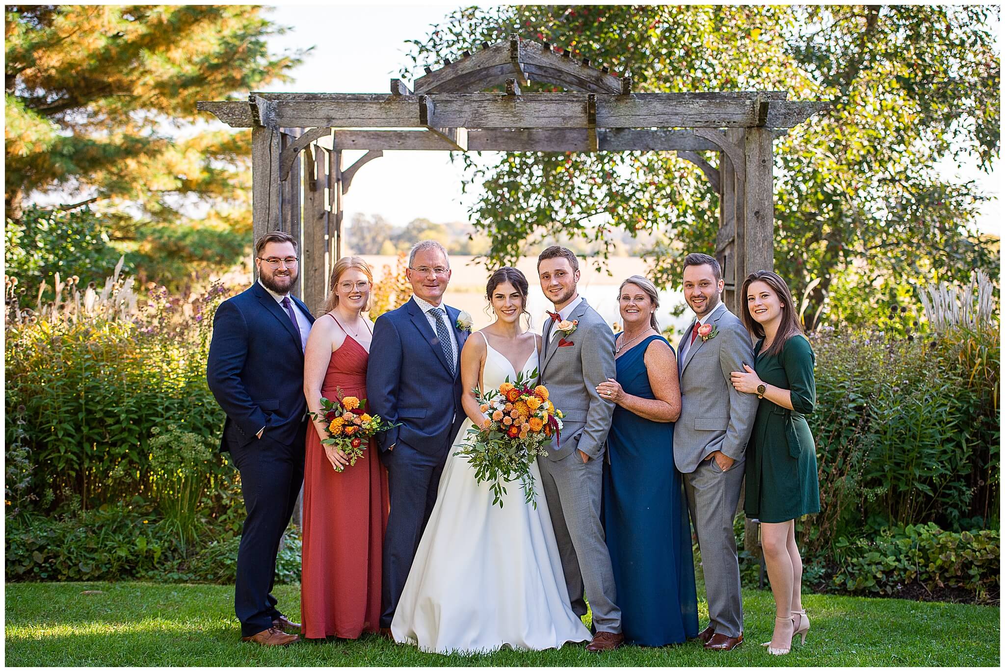 formal family photo of a bride and groom and their family members. Taken outdoors in the gardens of Strathmere Weddings