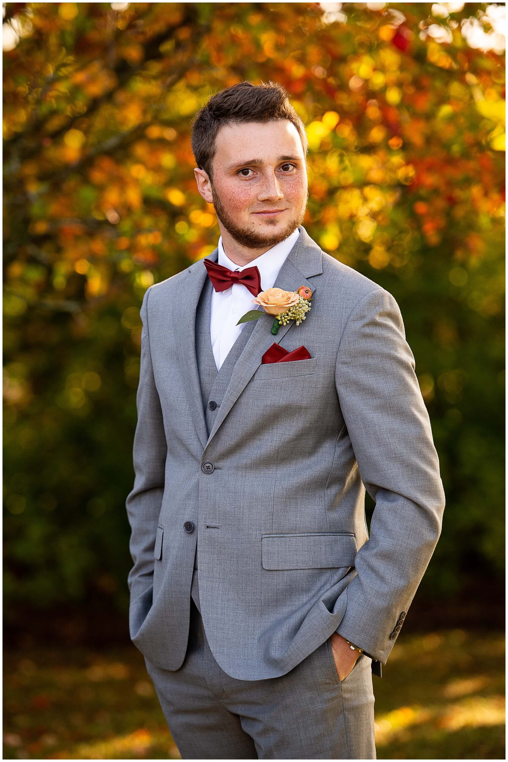 a portrait of a groom in a grey suit as he waits for his ceremony at Strathmere Weddings in Ottawa to start