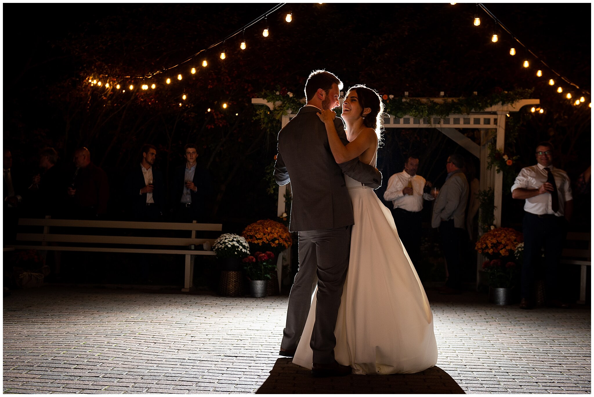 bride and groom first dance outdoors under Edison bulbs 