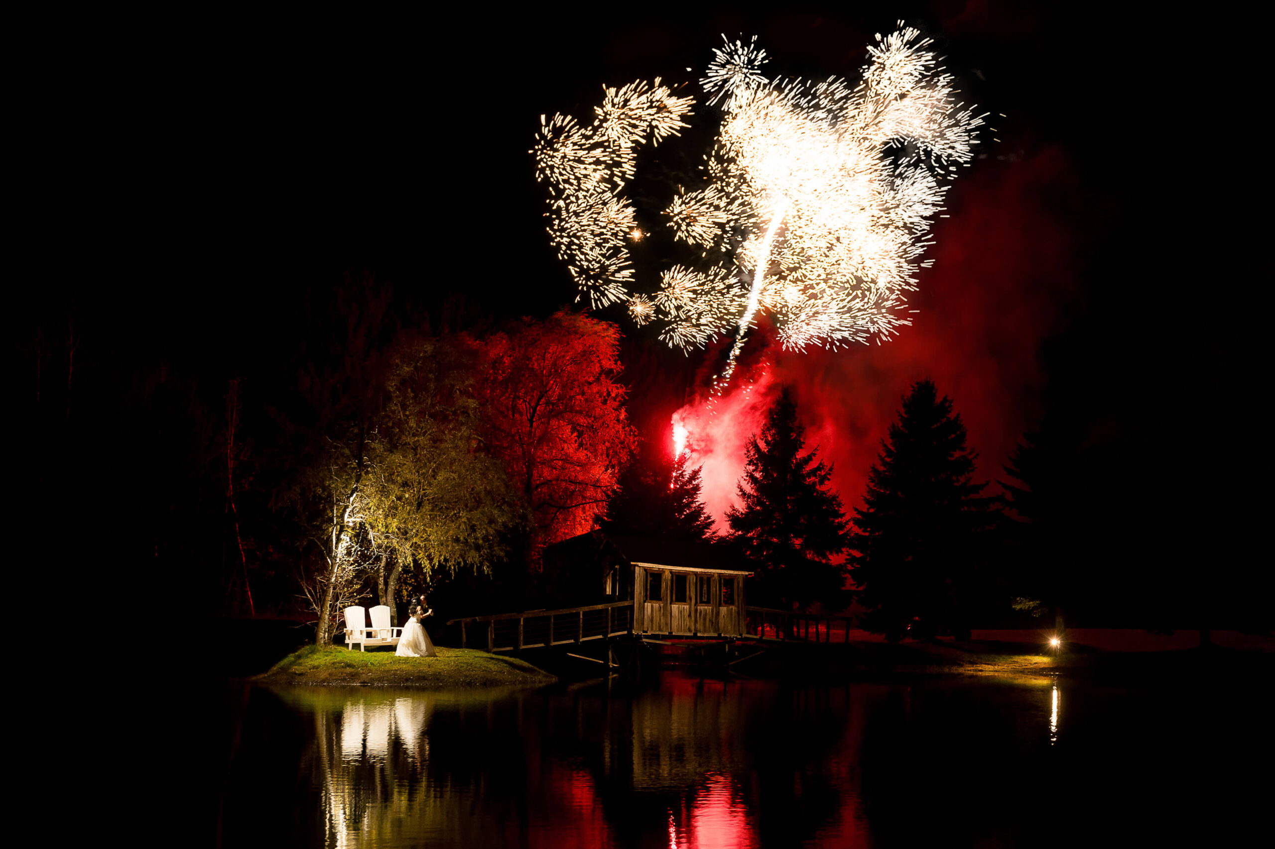 exploding fireworks in the night sky during a bride and groom's first dance at Bean Town Ranch weddings