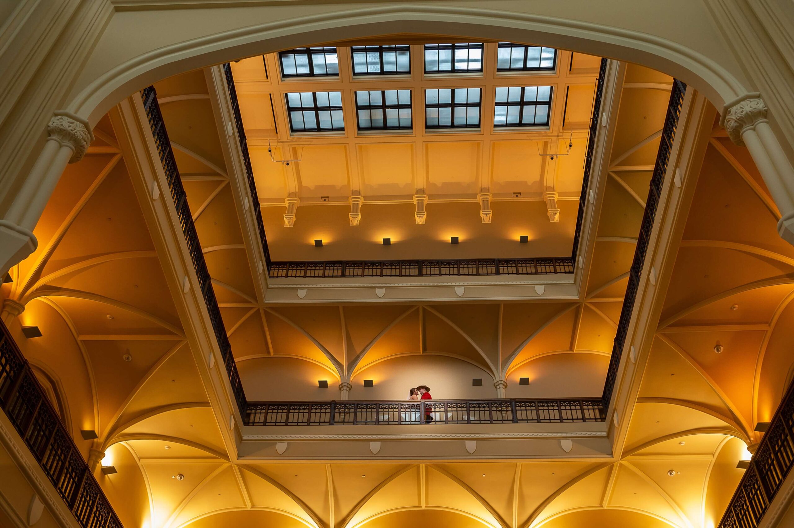 a photo of a bride and groom showing the ceiling details of the Museum of Nature weddings venue in Ottawa