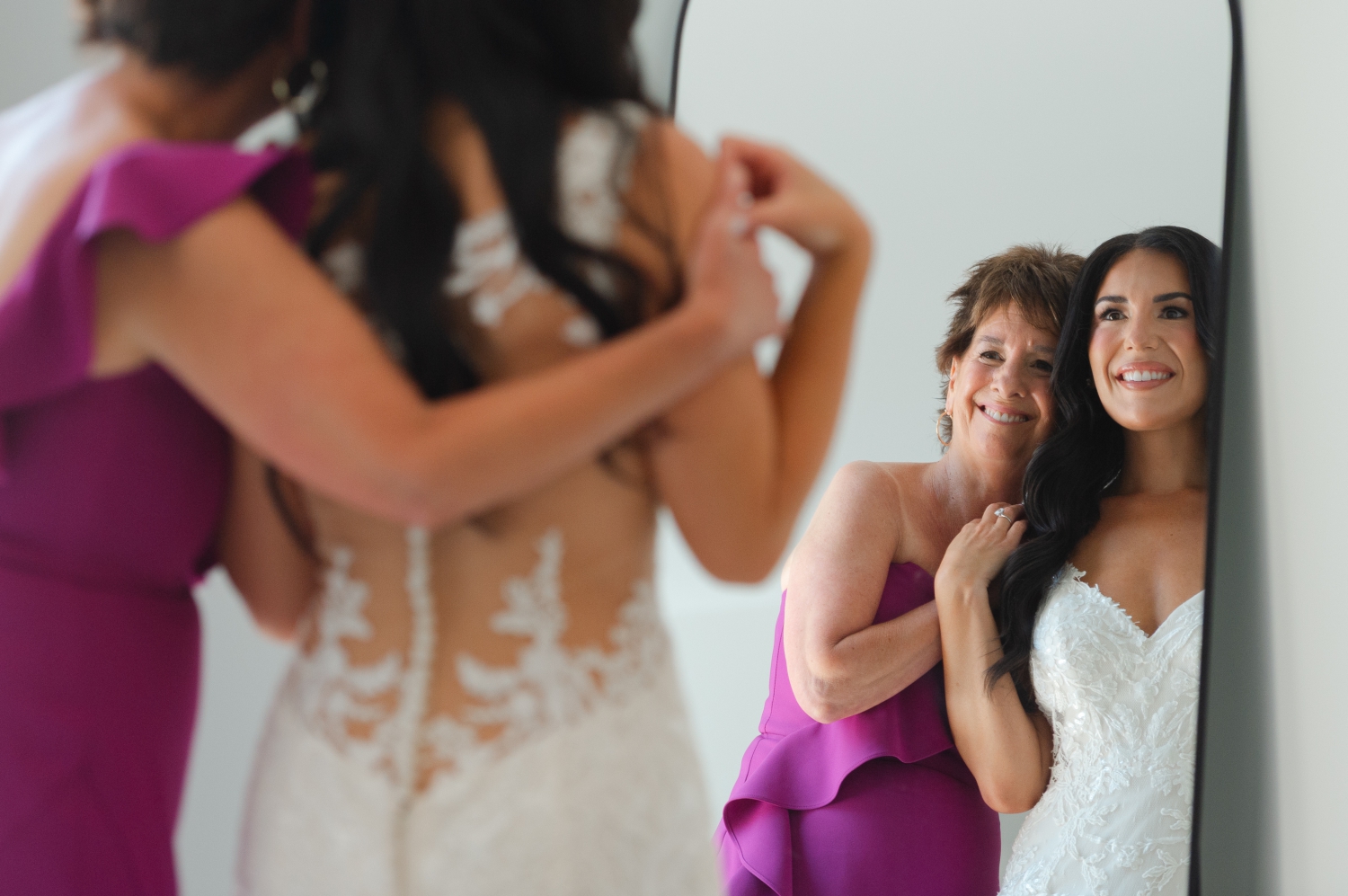a mom and bride look into the mirror and hug during their getting ready photos at the Bleeks and Bergamot Wedding Venue