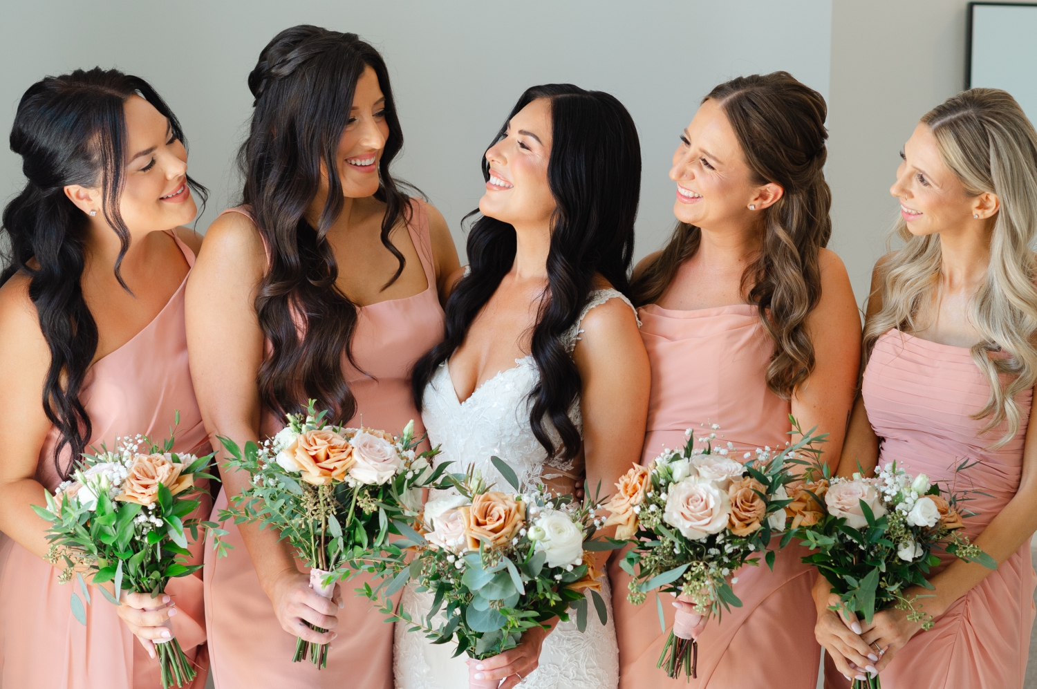 four bridesmaids in pink smiling with the bride during their getting ready photos at the Bleeks and Bergamot Wedding Venue