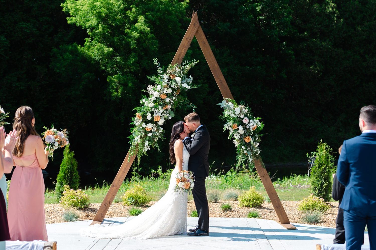 a bride and groom kiss at the front of the aisle for the first time during their Bleeks and Bergamot Wedding