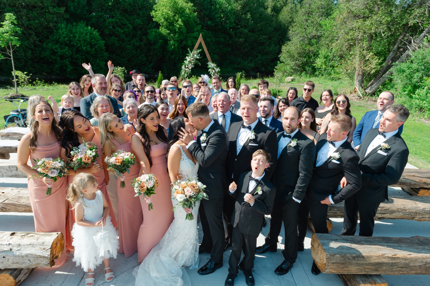 a group photo of a bride and groom and all their guests cheering at the end of the aisle at the Bleeks and Bergamot Wedding Venue