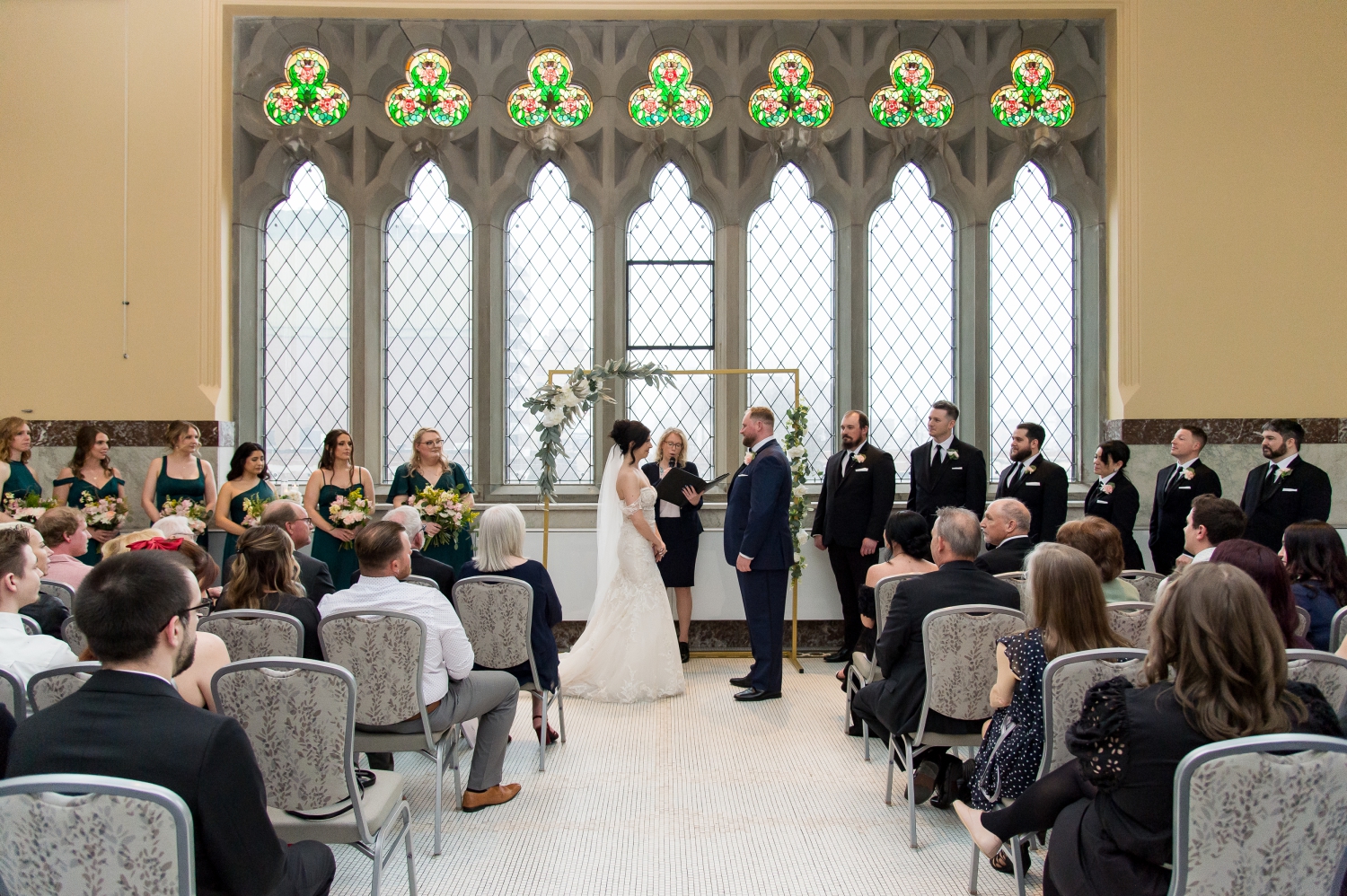 a wide angle photo of a bride and groom at the altar as part of their Canadian Museum of Nature Wedding Photography