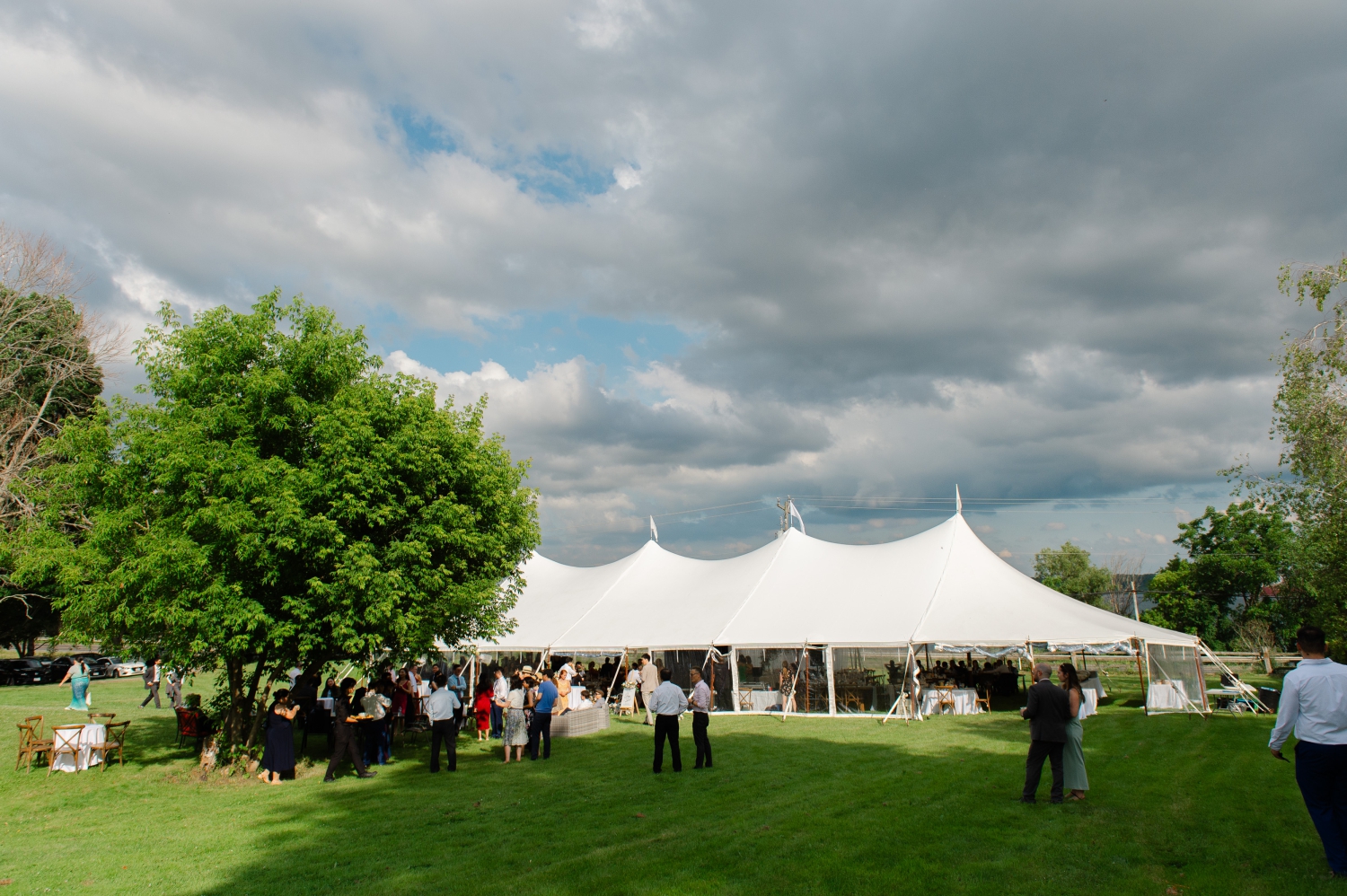 a wide angle photo of a tented reception as part of an Ottawa backyard wedding