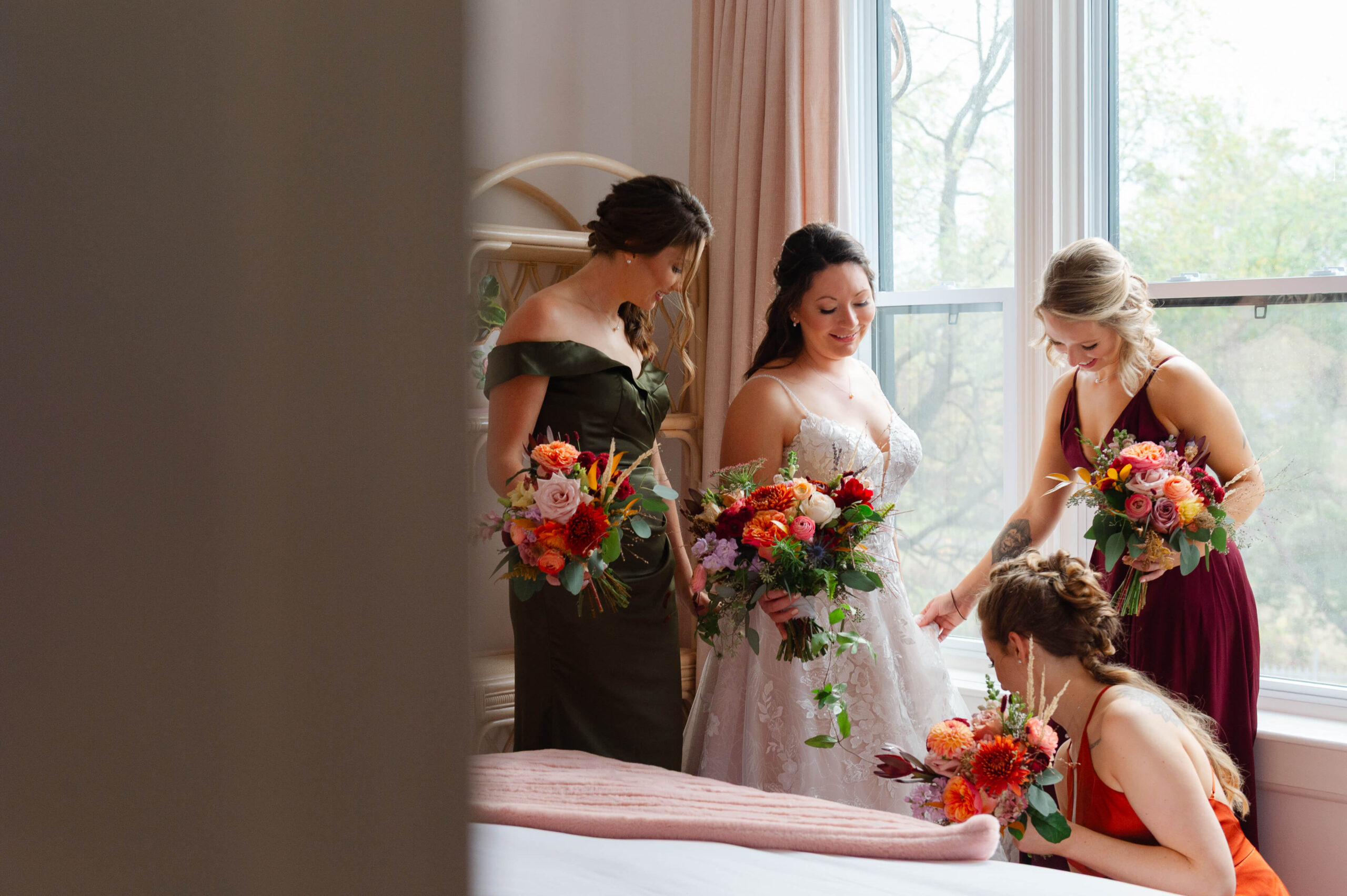 a bride and her bridesmaids getting ready in the Rose Room at Maple and Rose wedding venue and luxury accommodations. Captured by JEMMAN Photography
