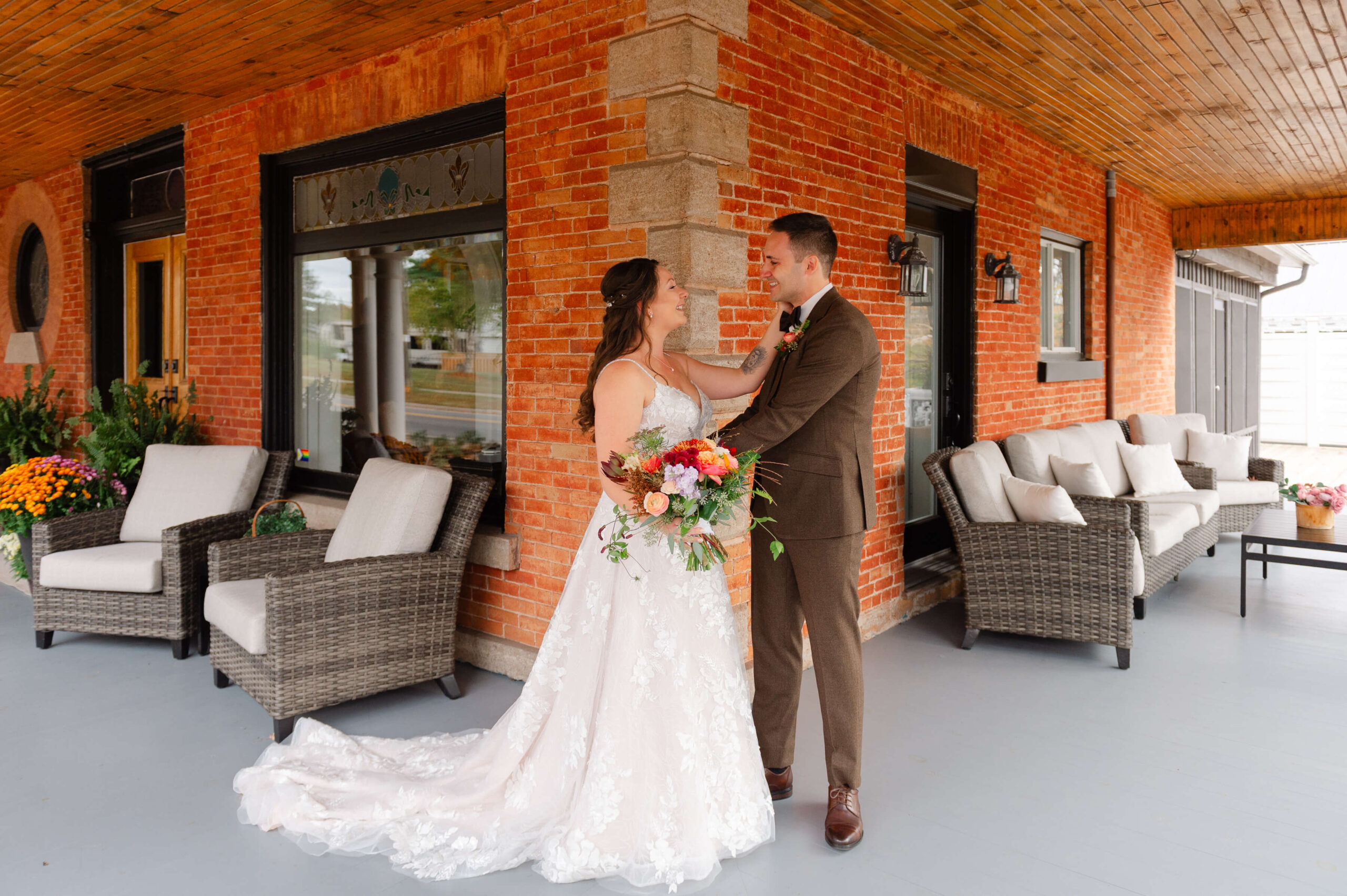 a bride and groom's joyous reactions after seeing each other for their First Look on the veranda of Maple and Rose wedding venue and luxury accommodations