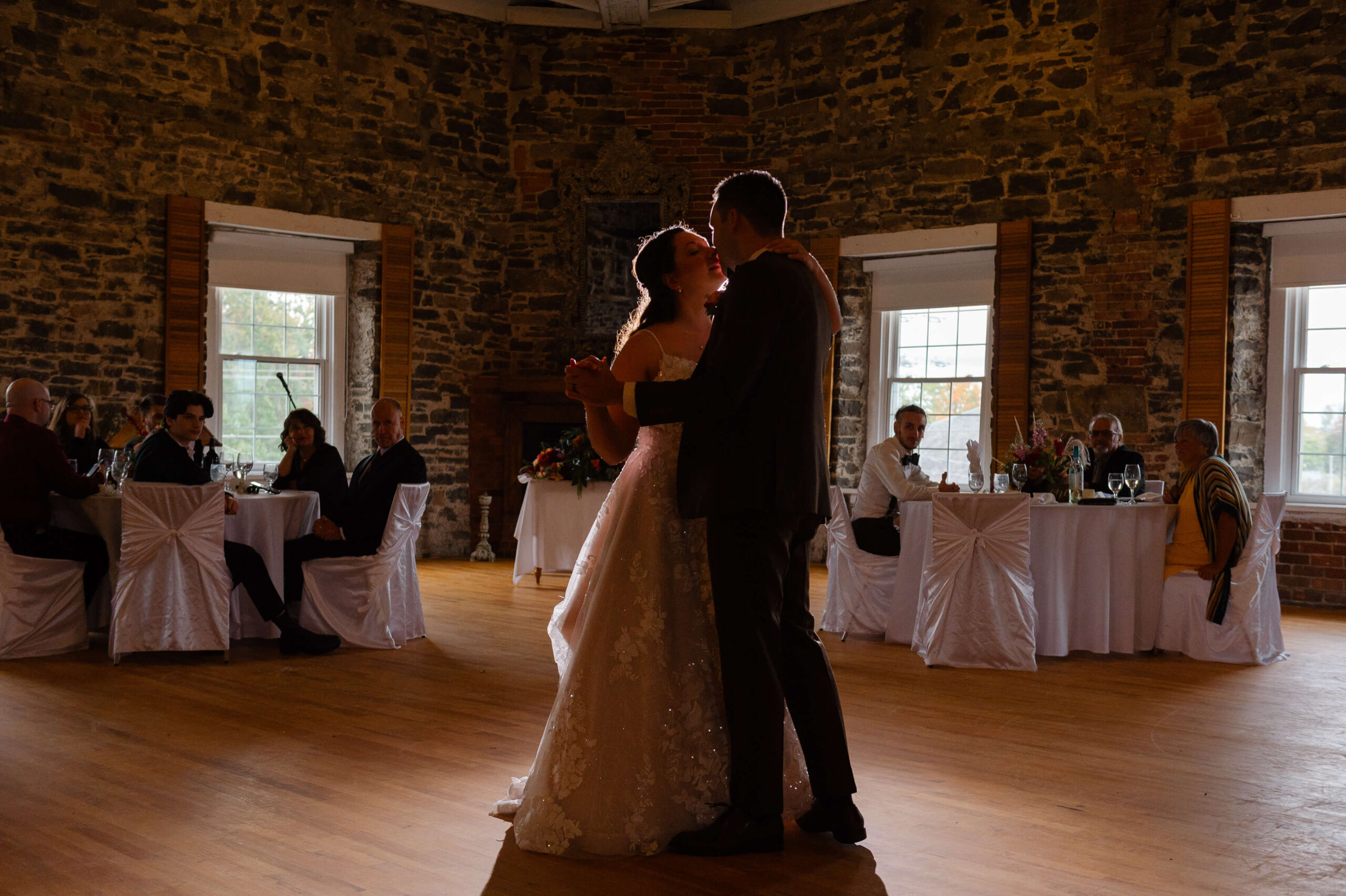 a bride and groom silhouetted with backlighting during their Maple and Rose wedding first dance