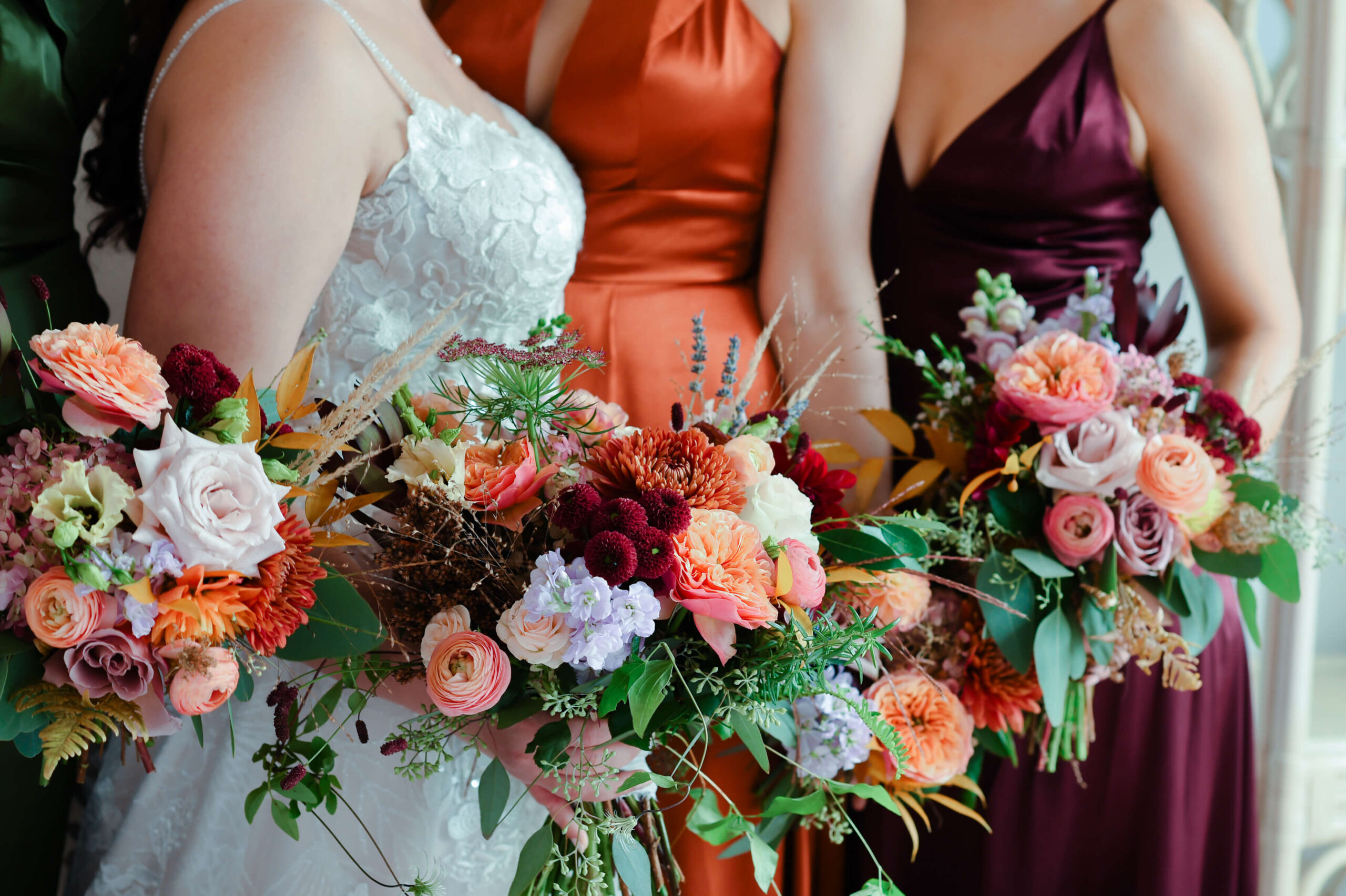 a photo of fall coloured bridal bouquets in rusts, burgundy and peach. Captured in the Rose Room at Maple and Rose weddings by Ottawa wedding photographer JEMMAN Photography