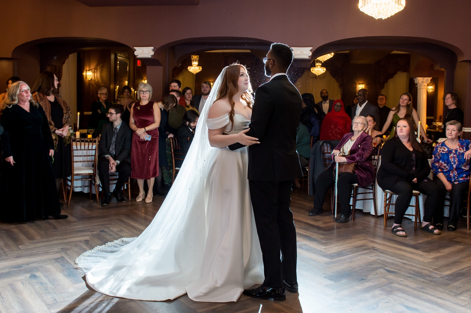 a backlit photo of a bride and groom during their first dance in the Ballroom of the Grand Hotel weddings. Captured by JEMMAN Photography