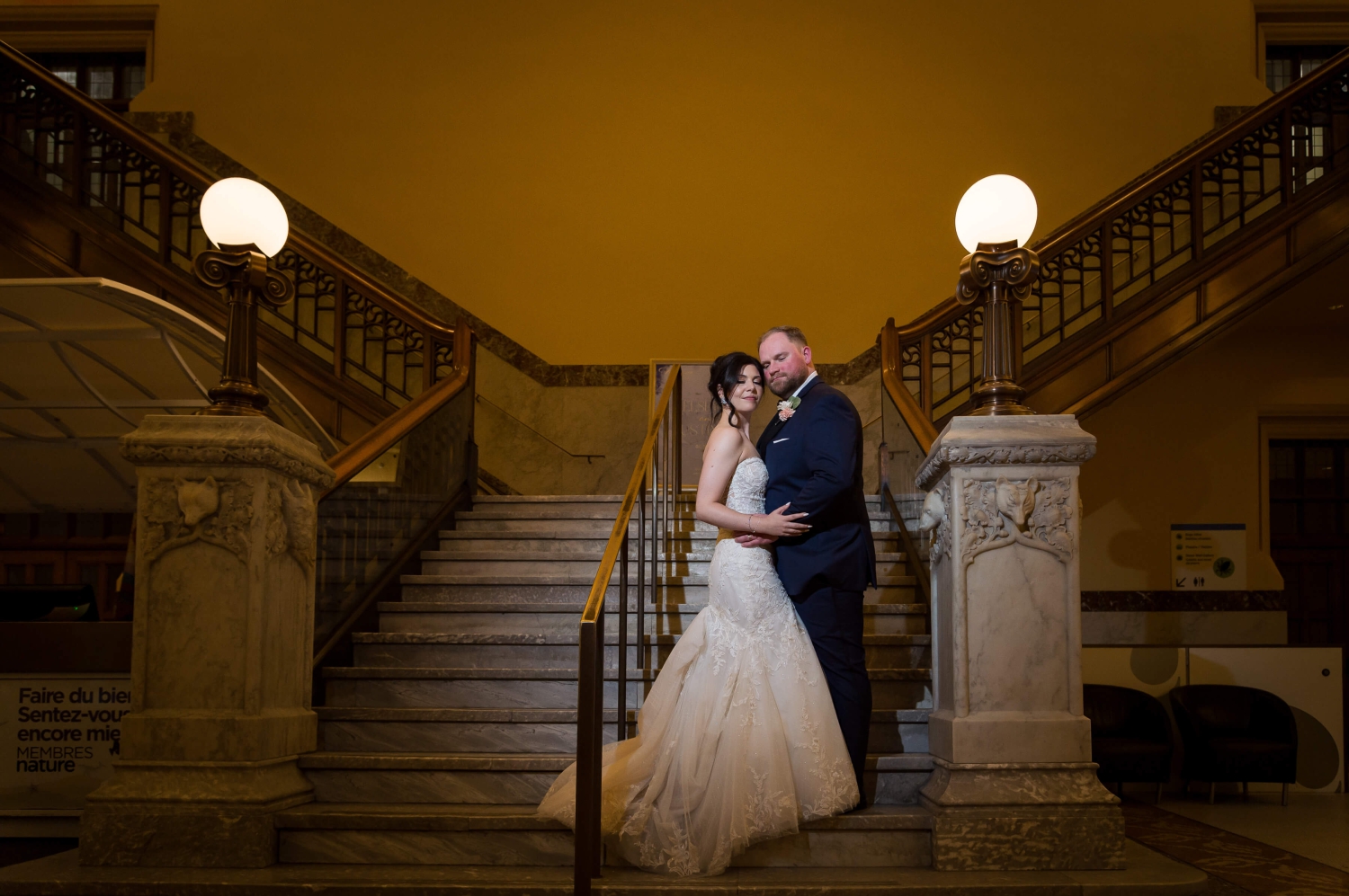 a dramatic portrait of a bride and groom on the grand staircase of the Museum of Nature, a downtown Ottawa wedding venue. Captured by Ottawa wedding photographer, JEMMAN Photography