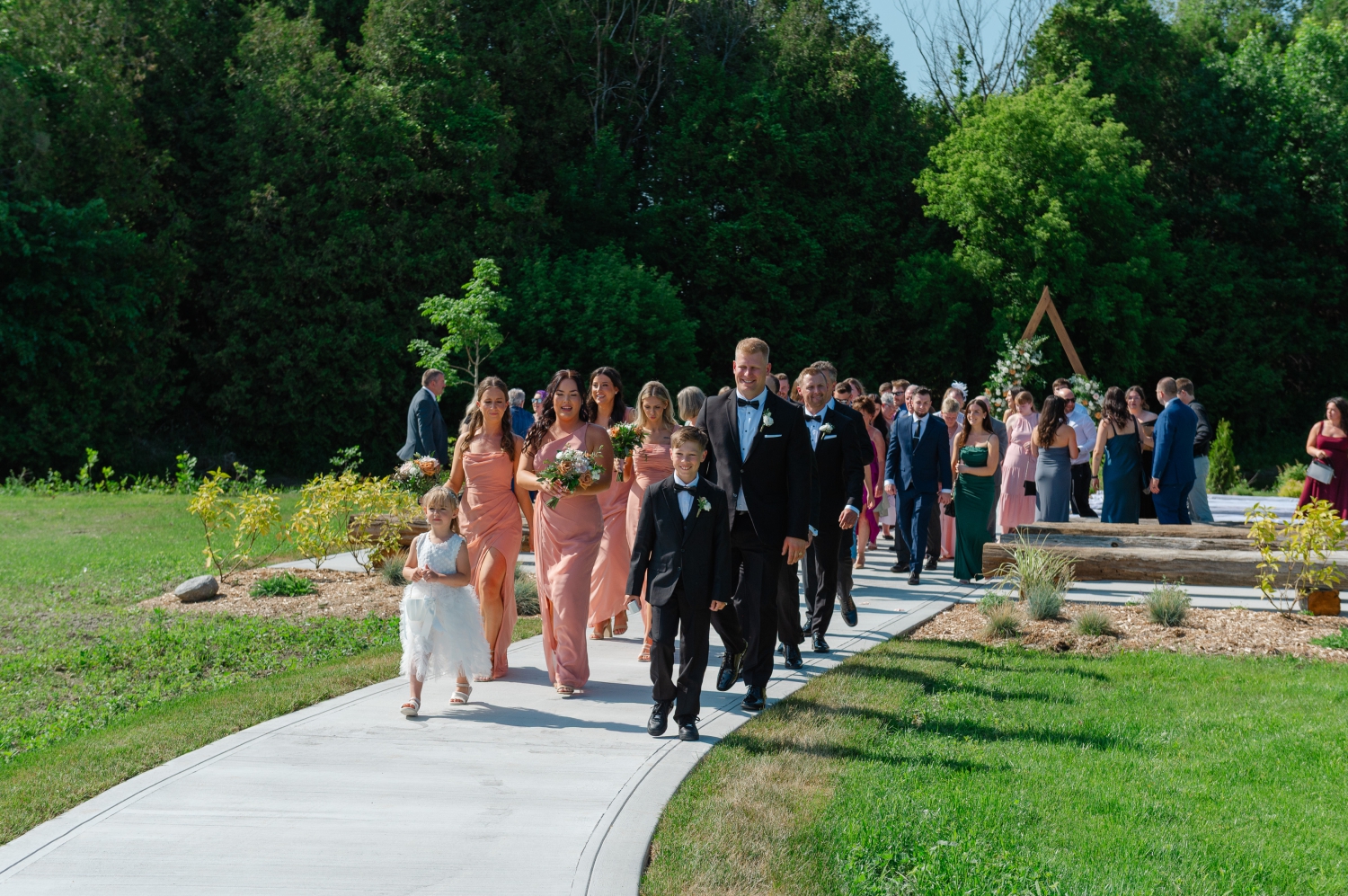 wedding guests walking out of the ceremony site at the Bleeks and Bergamot wedding venue. Captured by Ottawa wedding photographer JEMMAN Photography