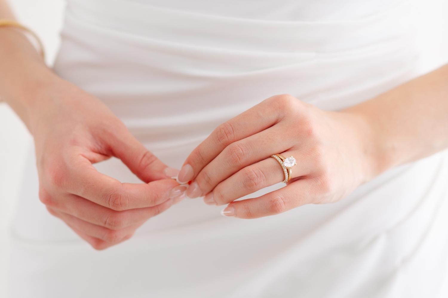 a photo of a bride's hands showcasing her gold engagement ring set during an Ottawa wedding. Captured by JEMMAN Photography